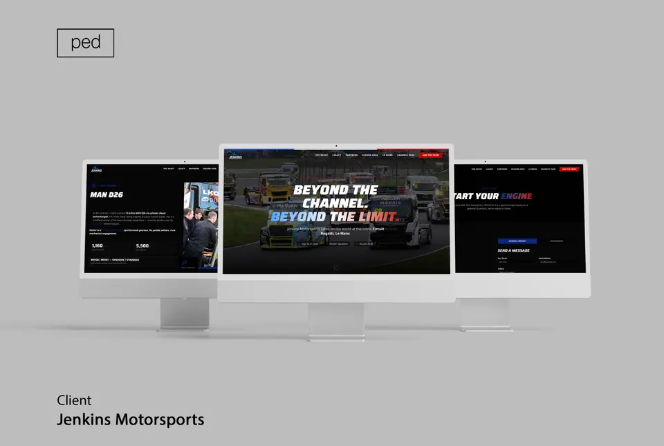 Three monitors showing the Jenkins Motorsports homepage, a truck page, and contact.